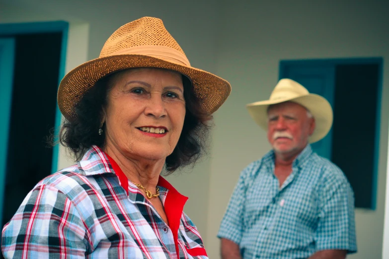 an older couple in hats and plaid shirts