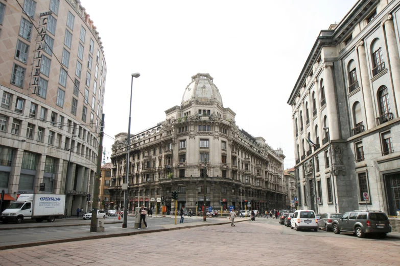 a city street with several large, old buildings and traffic lights