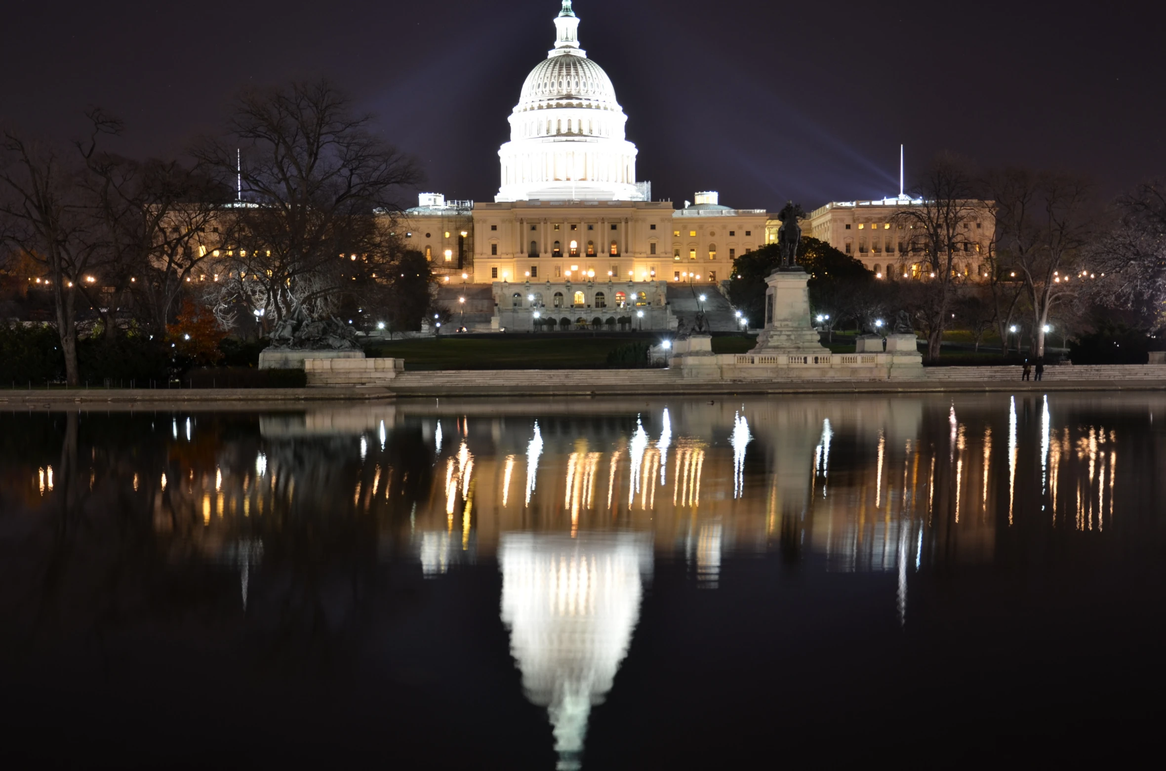 a building that has many lights on near the water