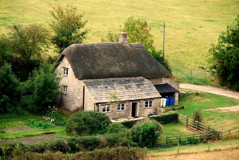 a small rural house surrounded by wooded hills