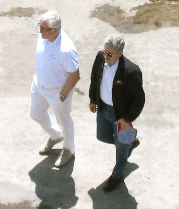 two men walking side by side near each other