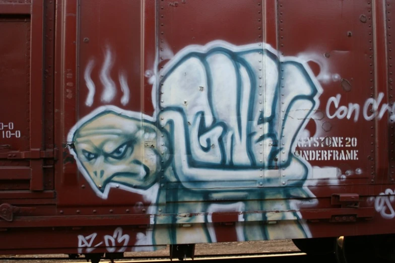 a red train car with grafitti on it