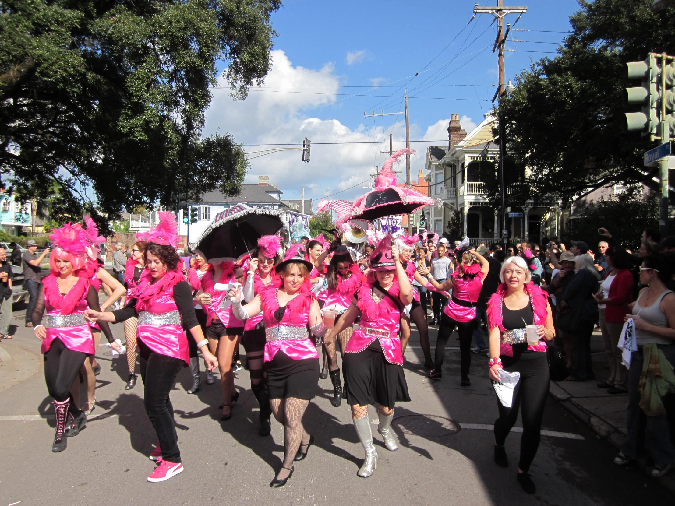 people dressed in pink are marching down the street