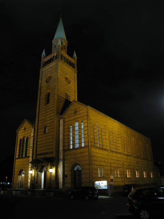 a church is lit up in the dark