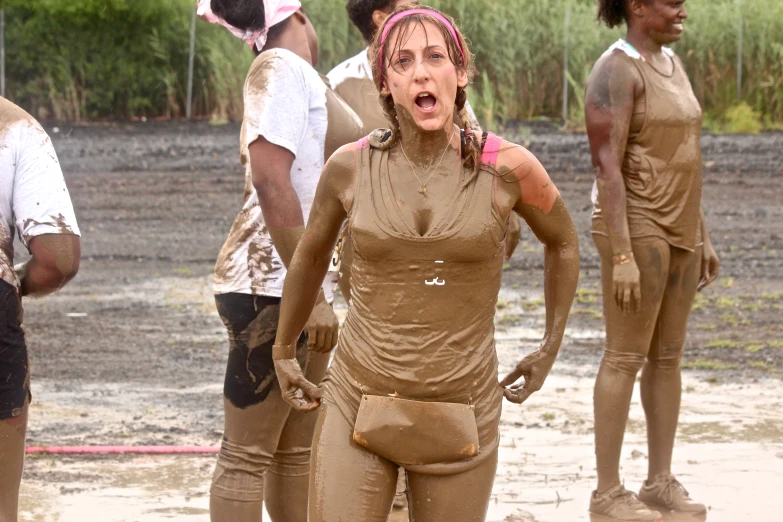 a women with mud painted on her face is walking