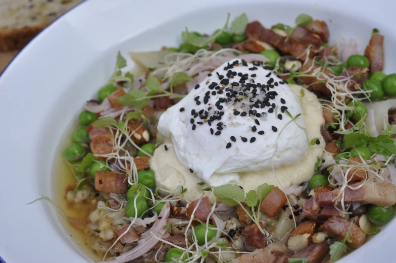 food in a white bowl has meat and greens