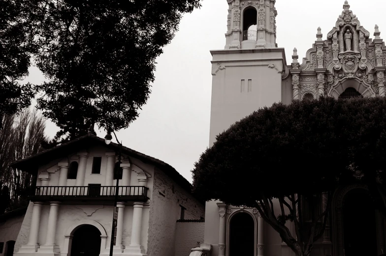 a tall tower with a clock on it next to a church