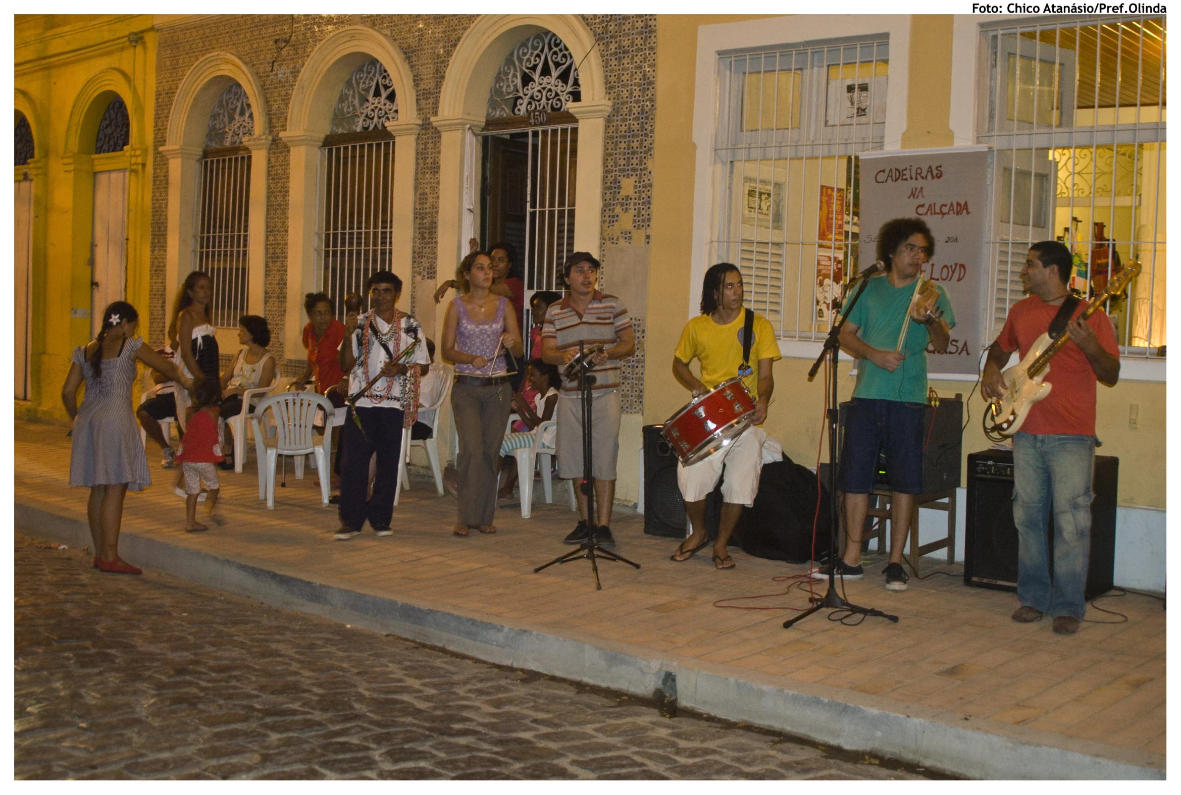 a group of people singing outside on the street