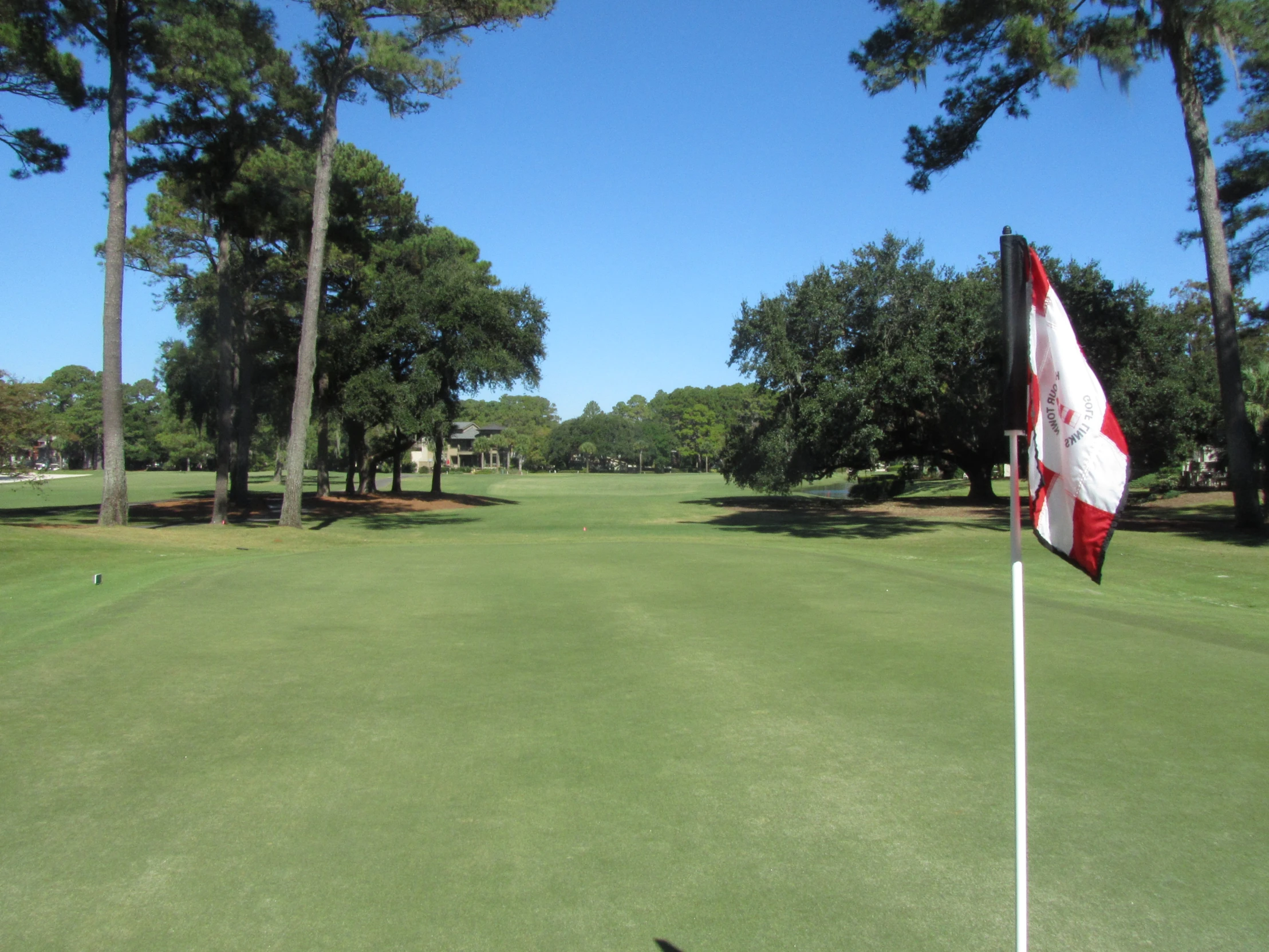 a golf course with the canadian flag on top