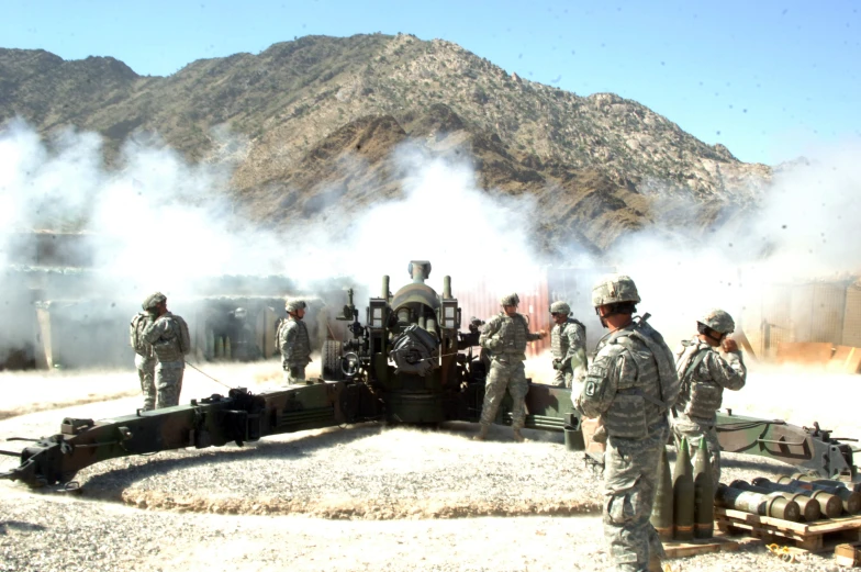 a group of soldiers standing around a steam engine