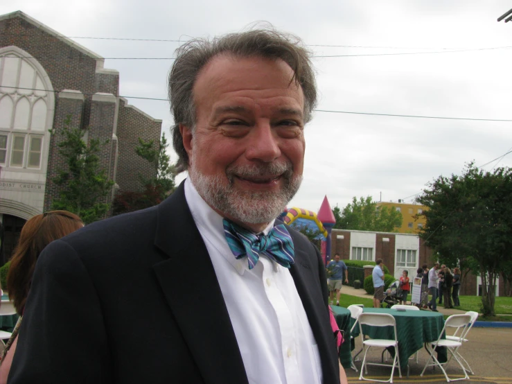 a man wearing a suit and a blue bow tie