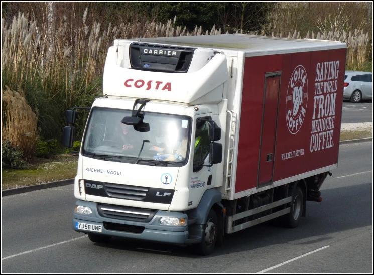 an truck driving on the street with red paint