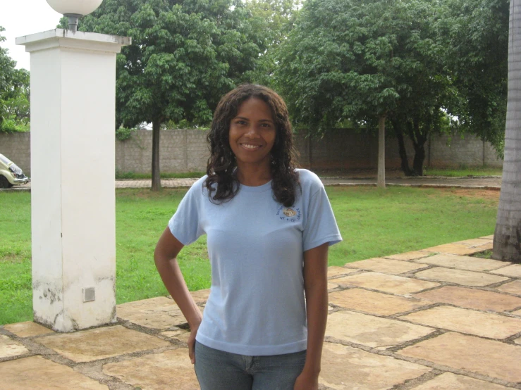 a woman standing outside by herself in a sunny day