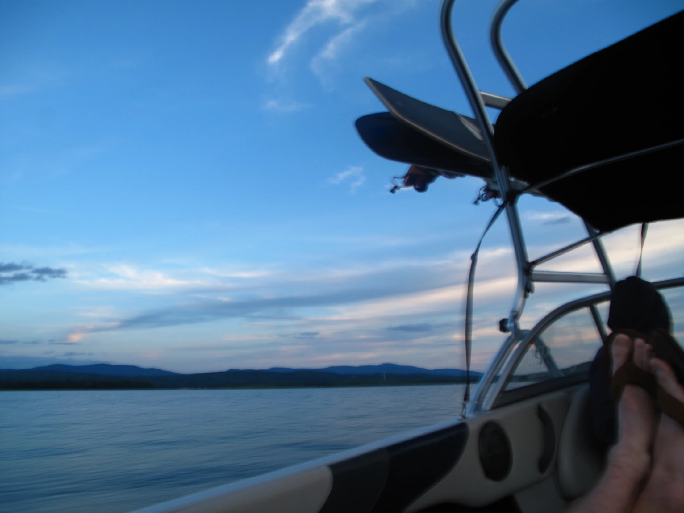 person holding up their feet on a boat