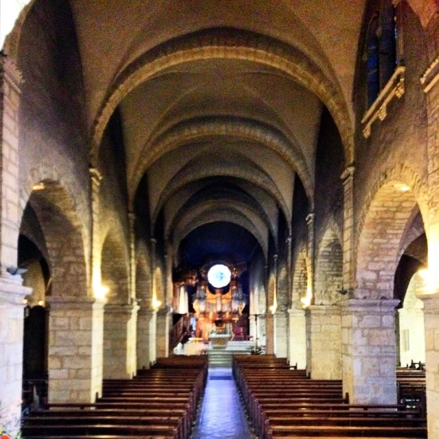 a view down a long aisle lined with pews