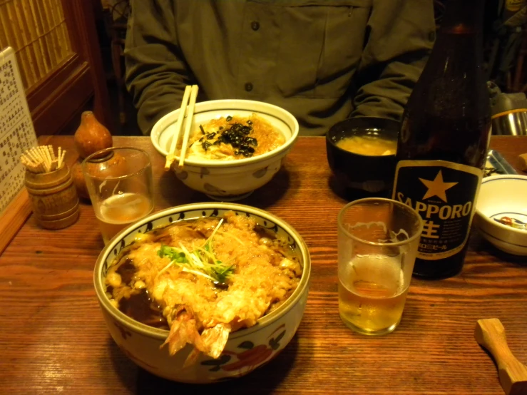 a man sitting at a table in front of a bowl of food