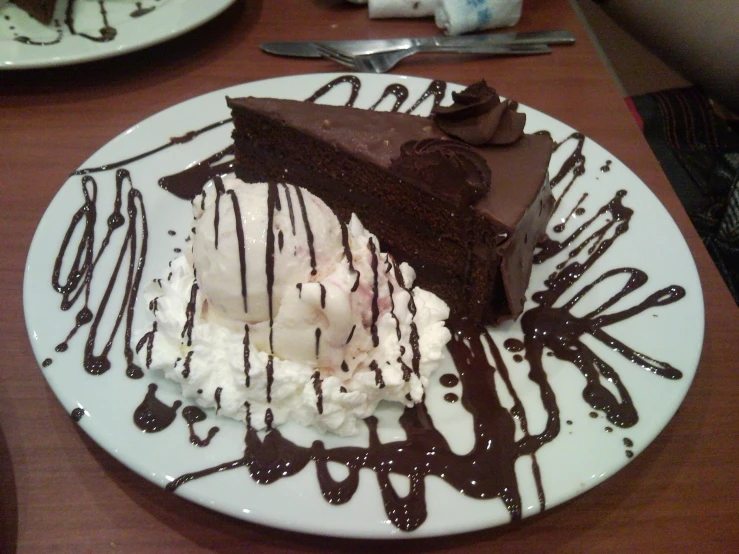 a plate of ice cream and chocolate covered pie