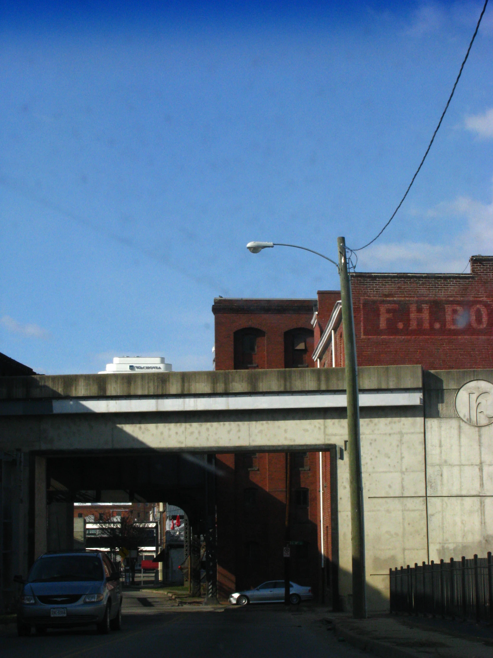 a tall bridge that is over a city street