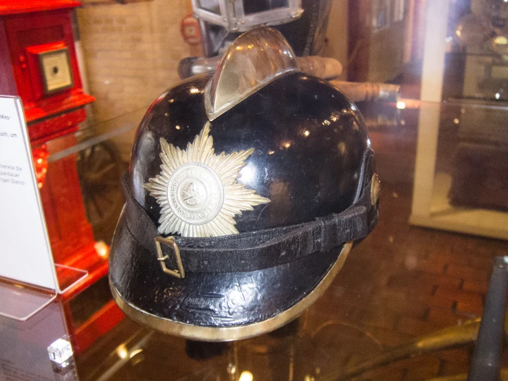 an elaborately decorated german helmet sits on display