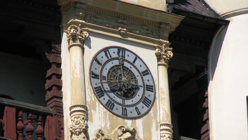 a clock tower showing five o'clock and is surrounded by ornate columns