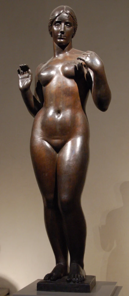 a large bronze statue of a woman with an open top