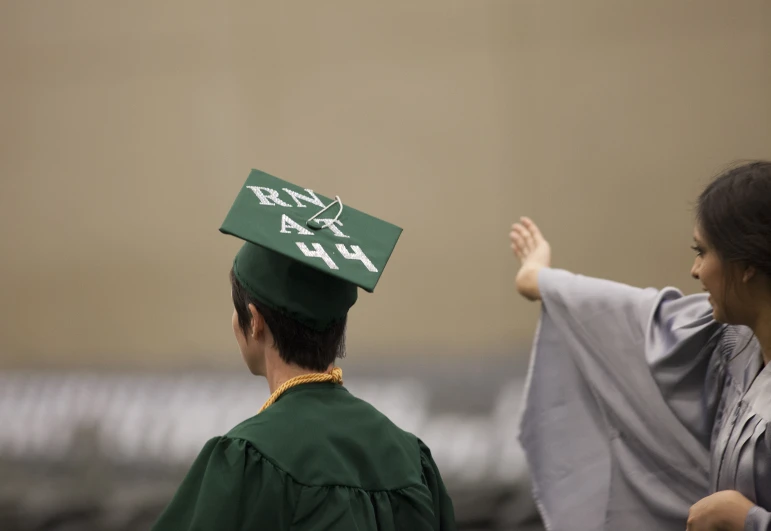 a graduate is getting his picture taken while walking on the field