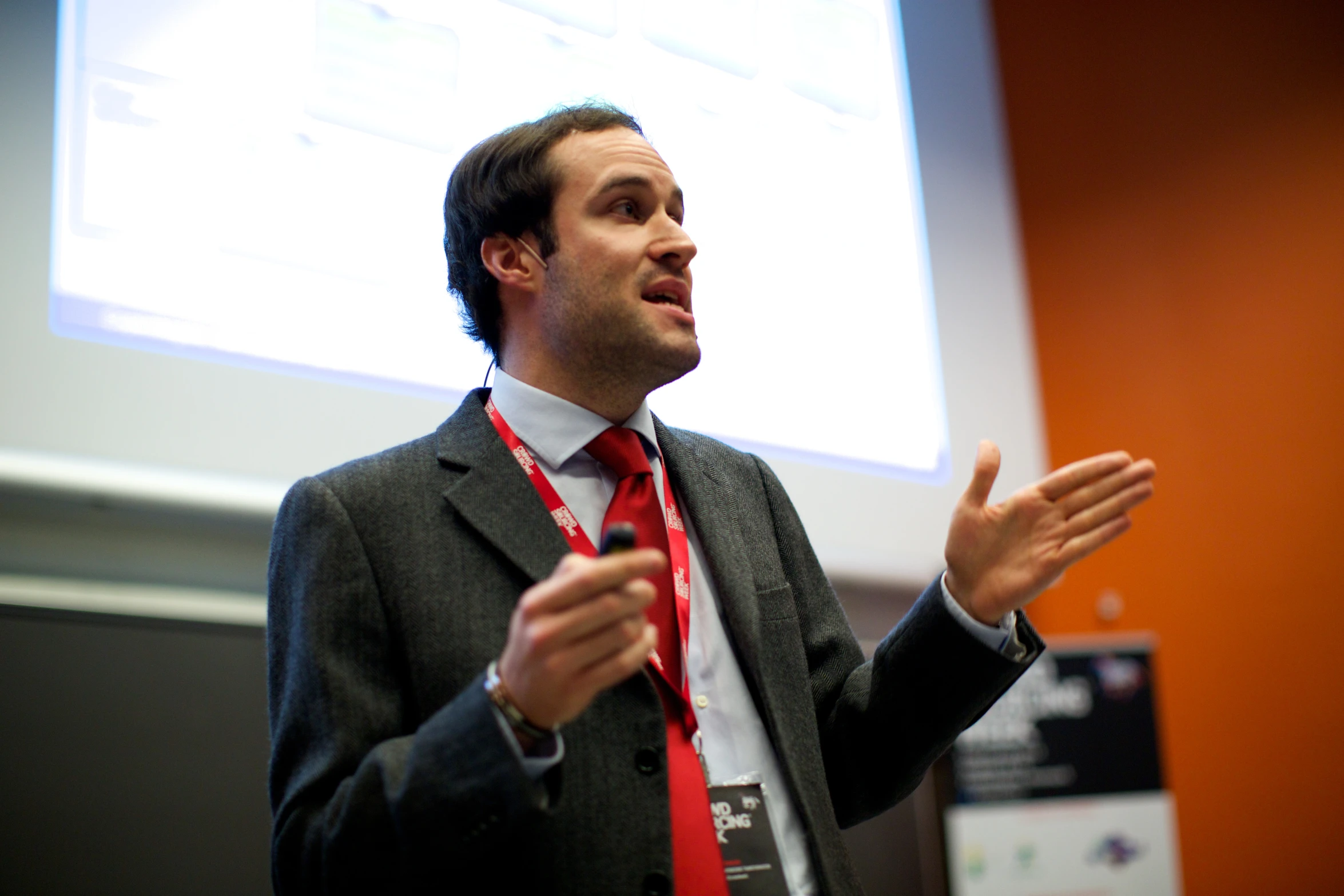 a man in a suit giving a lecture