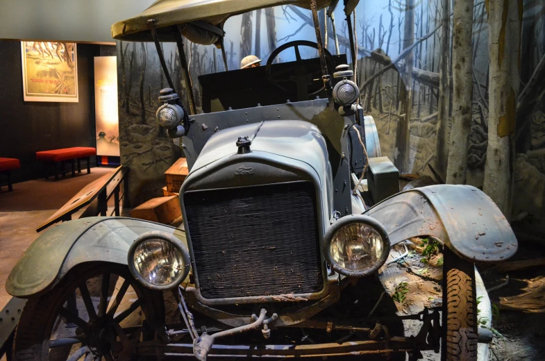 old antique truck sitting in the woods with a canopy