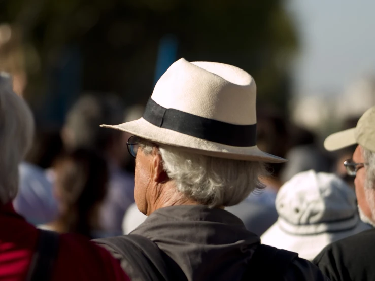 two older people are standing together in the sun