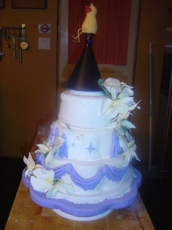 a wedding cake decorated with flowers on a wooden table