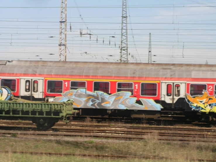 an old train on the tracks with some graffiti