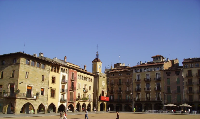 two large buildings are behind each other in an open area