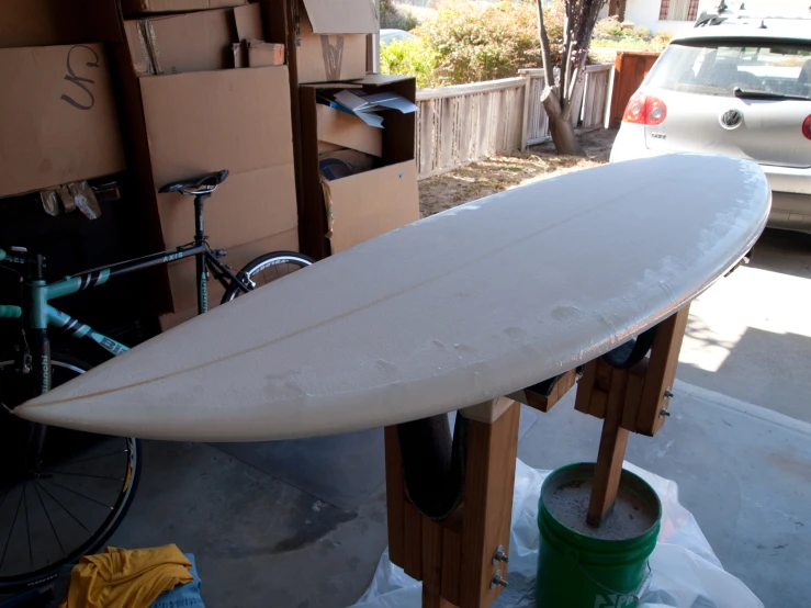 a surfboard sits on a shelf outside a building