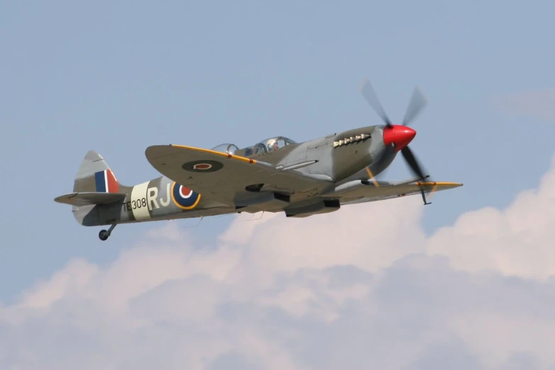 a plane flying in the air with clouds