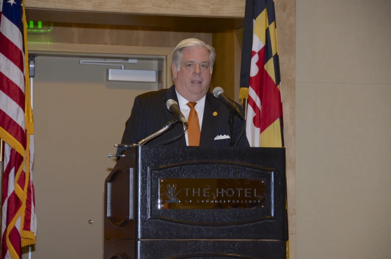 a man that is standing up in front of a podium