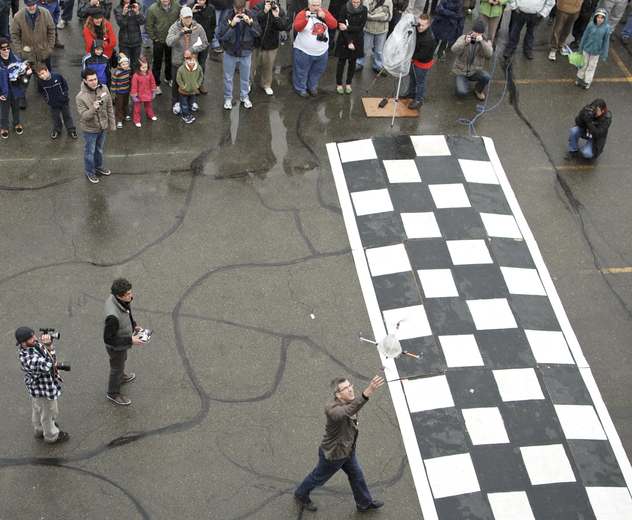 a group of people standing around an oversized chess board