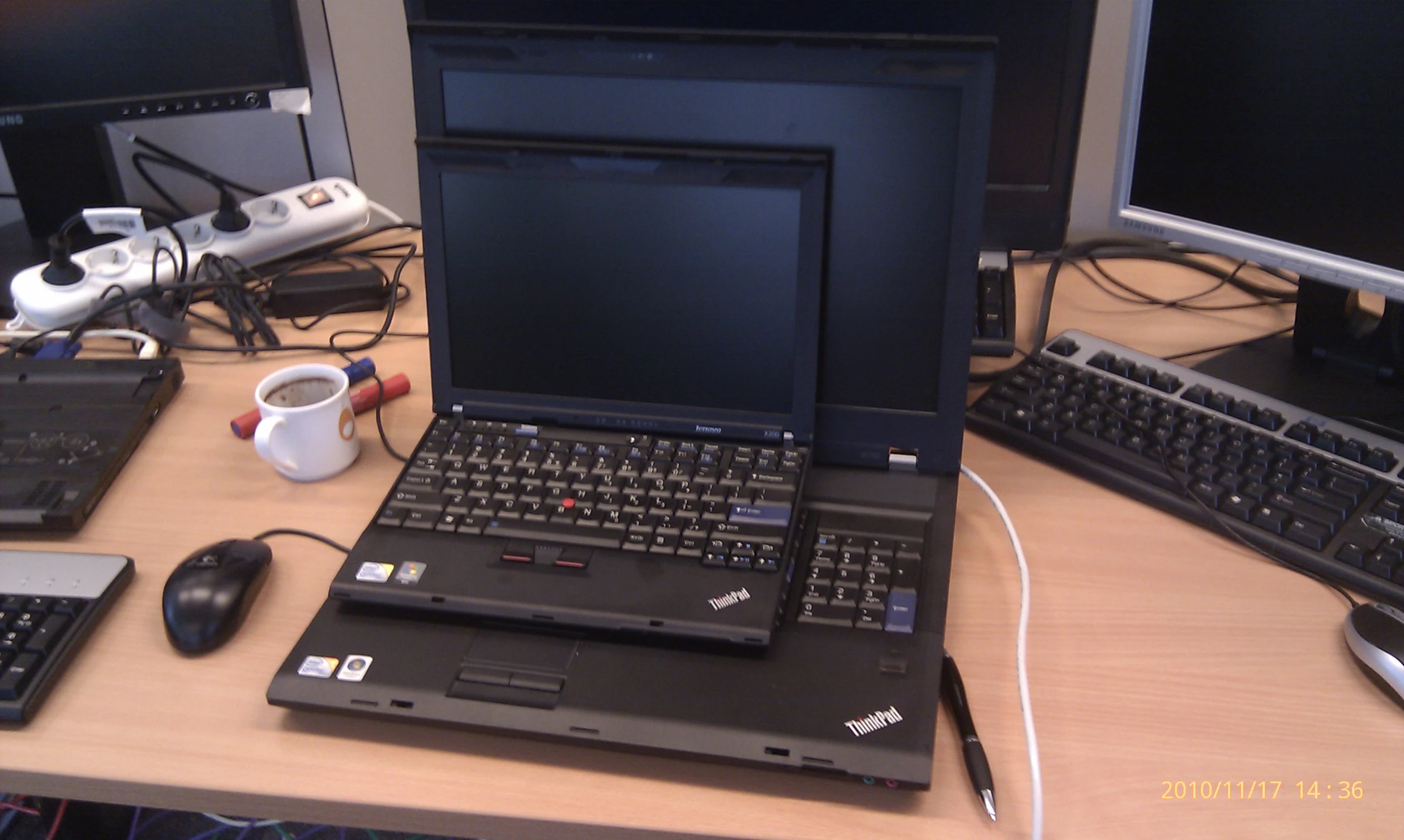 laptop computer sitting open on a table with a mouse and keyboard