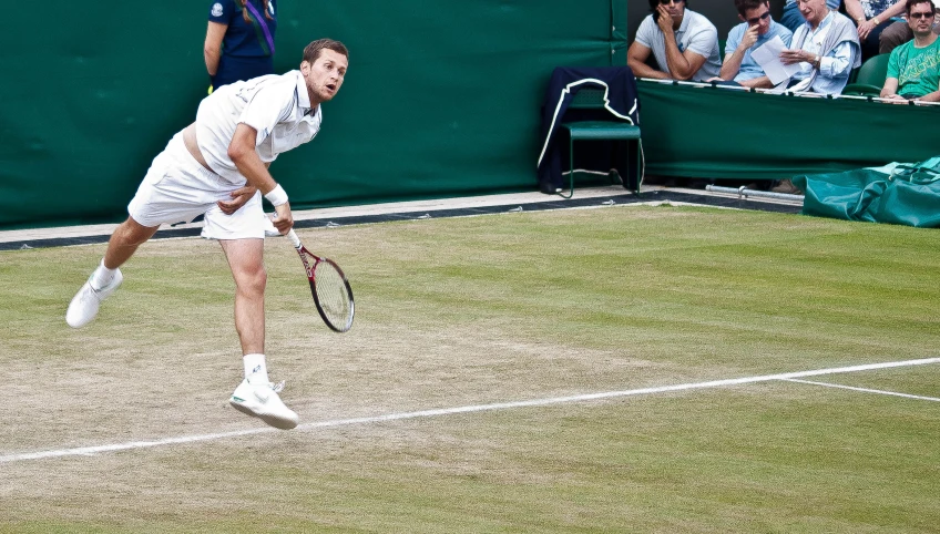 a man playing tennis in the middle of a game