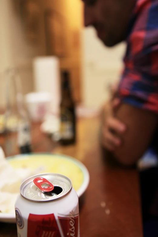 a person sits at a table near a plate with food on it