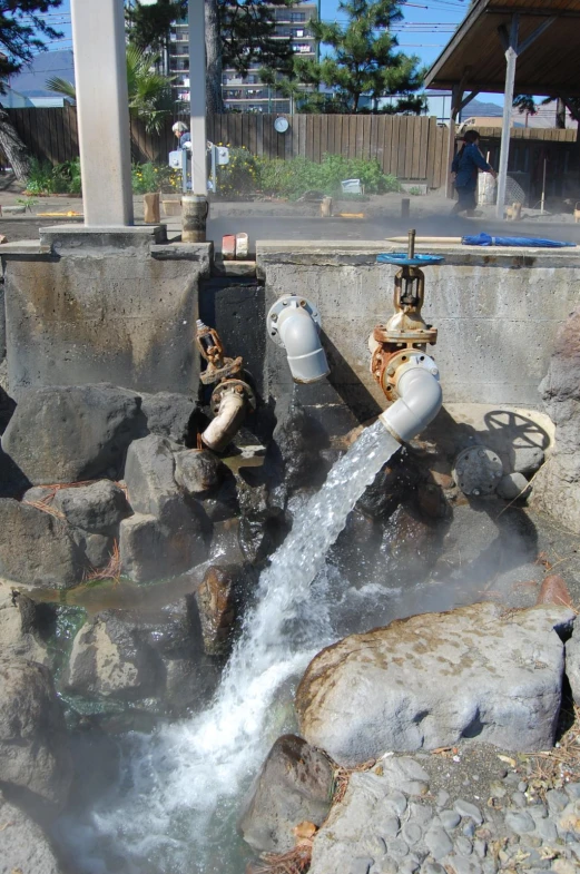 two white fire hydrants on top of rocks