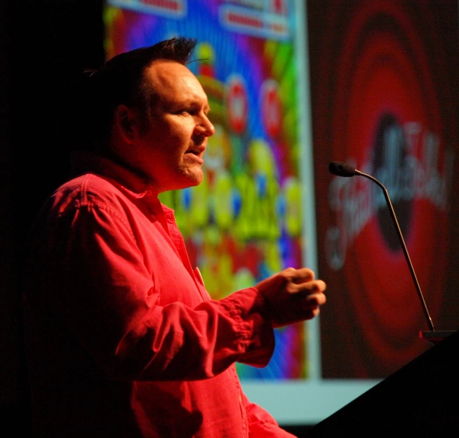 a man giving a speech to an audience