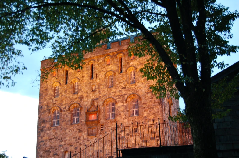 an old building with balconies that is brown and orange