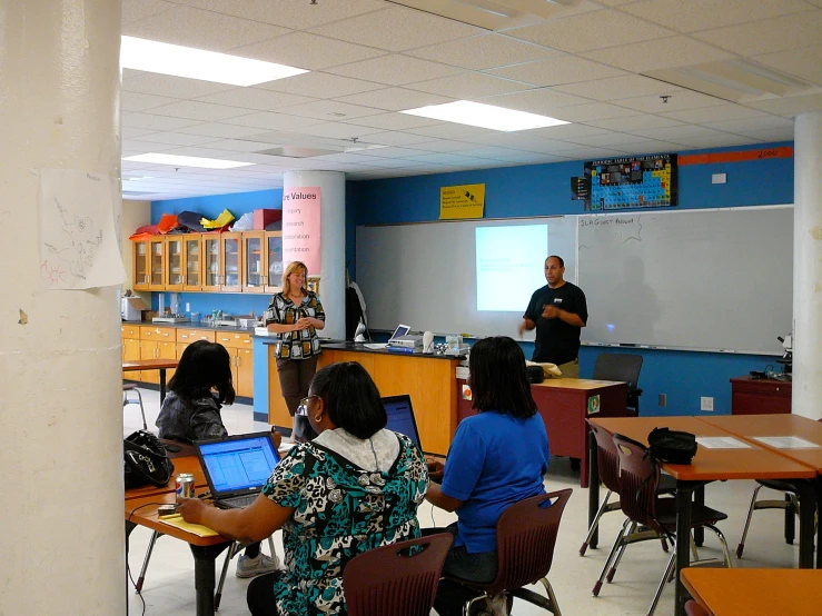 a classroom with children on laptop computers