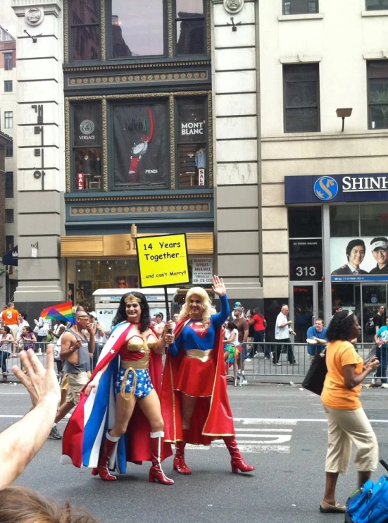a group of women dressed as wonder girls are on a city street