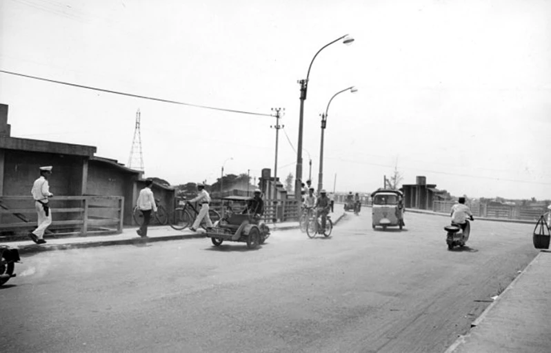 several men walking on the street and cars