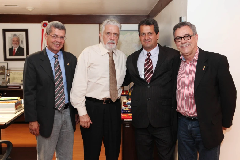 several businessmen smile for a pograph while standing together