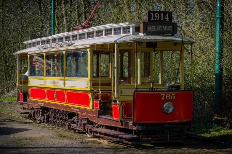 a red trolley car with the number 781 sitting on a track