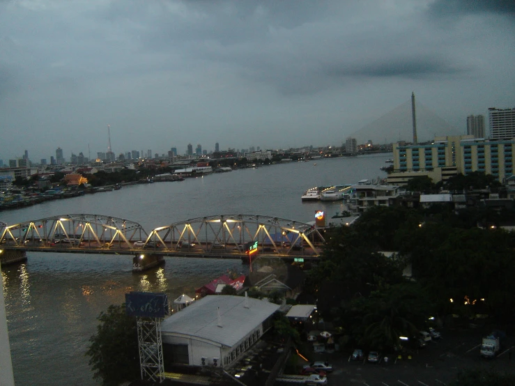 a nighttime view of the city and its bridge over the water