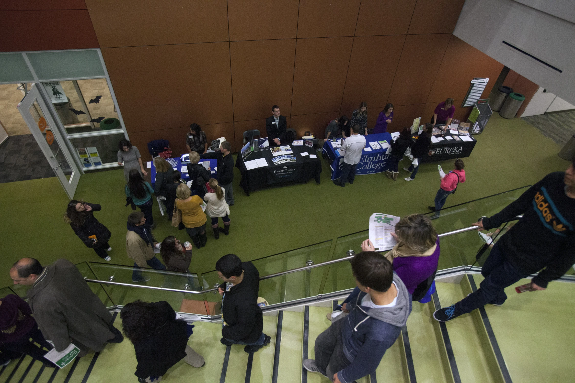 a group of people are lined up on a stairwell with table's