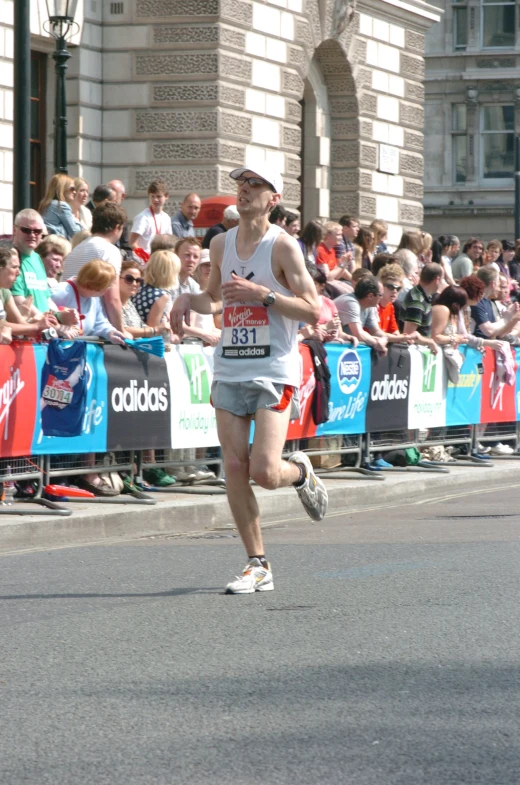 a man running in a marathon while a crowd watches